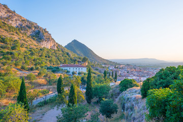 City seen from a hill in the light of sunset 
