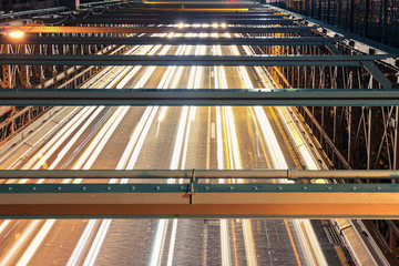 Fototapeta premium Traffic on the Brooklyn bridge at night, viewed from above. Strong horizontal and vertical lines