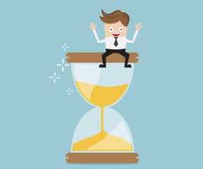 businessman sitting on hourglass, business time management concept