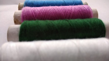 isolated multicolor sewing threads on white background 