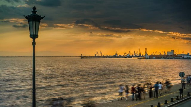 Thessaloniki Port at Sunset, with people walking by the sea , 4K video