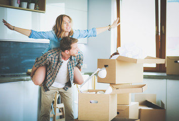 Portrait of young couple moving in new home