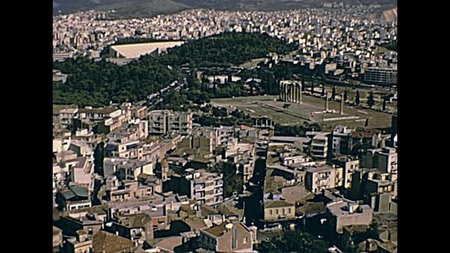 Close out from Ancient Greek Temple of Olympian Zeus ruins. The Olympieion or Columns of the Olympian Zeus. Athens aerial view from Acropolis. Restored historical 70s archival footage on 1972 Greece.