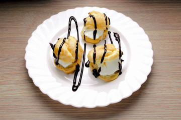 Profiteroles with ice cream with chocolate
