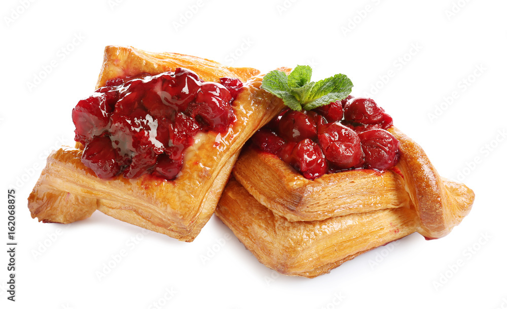 Wall mural delicious puff pastries with cherry on white background