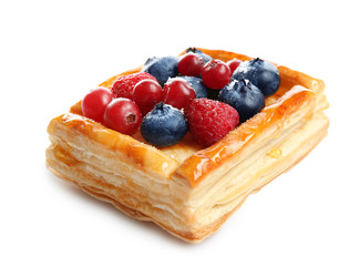 Delicious puff pastry with berries on white background
