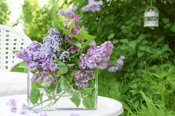 Lilac flowers on table in beautiful garden
