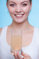 Woman holding glass with water and effervescent tablet