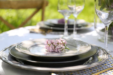 Beautiful table setting with lilac flowers decoration