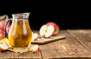 Apple Cider on wooden background (selective focus)