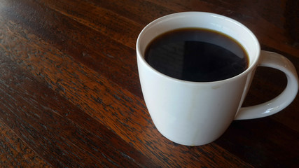 americano coffee in white mug on wooden table