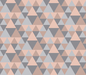 Fototapeta premium Modern style vector illustration for surface design. Abstract seamless pattern with triangle motif in natural beige and gray colors.