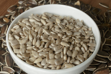 Dried unshelled sunflower seeds on a wooden table. Vegetarian food