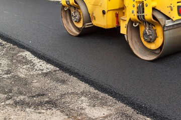 New asphalt road. Road asphalt works. Construction works. - obrazy, fototapety, plakaty