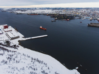 Beautiful aerial air winter vibrant view of Murmansk, Russia, a port city and the administrative center of Murmansk Oblast, Kola peninsula, Kola Bay, shot from quadcopter drone
