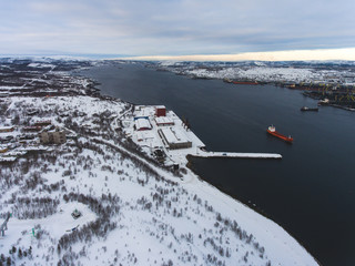 Beautiful aerial air winter vibrant view of Murmansk, Russia, a port city and the administrative center of Murmansk Oblast, Kola peninsula, Kola Bay, shot from quadcopter drone
