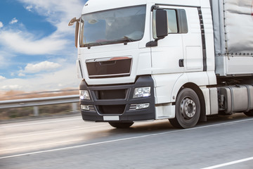 Naklejka premium truck transports freight on highway