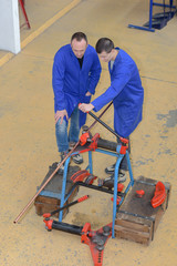 workers in modern storehouse with forklift