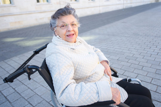 image of disabled positive old woman on wheelchair