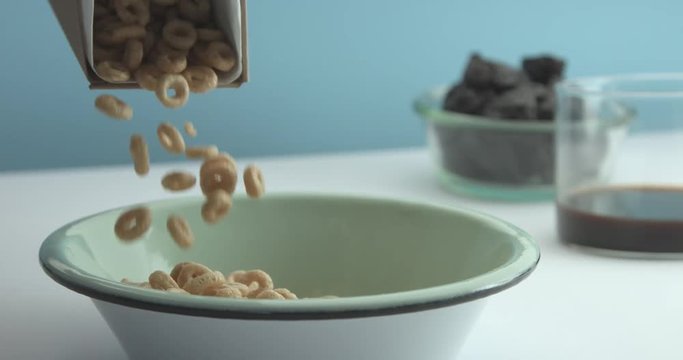 corn flakes rings falling on a bowl slow motion. Breakfast theme footage