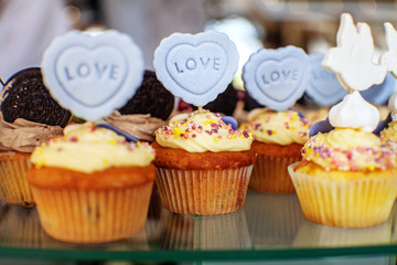 Tasty cupcakes. The inscription is love. The concept of food, party and wedding.