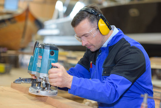 capenter wood sanding at a machine