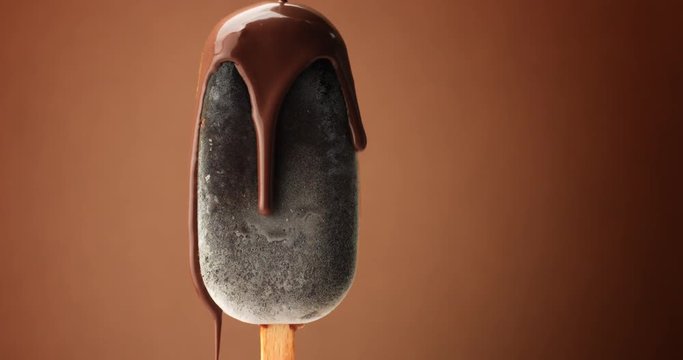 chocolate ice cream on a stick and liquid chocolate covered it. Different chocolate textures