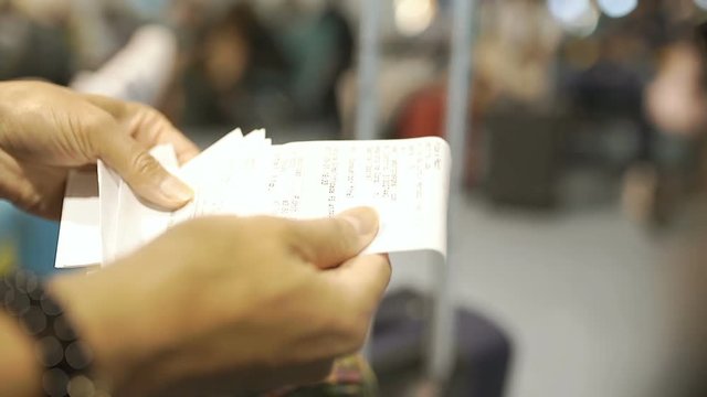 Woman holding receipts and checking them, steadycam shot
