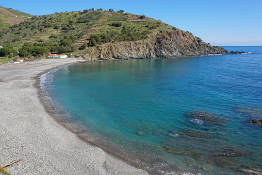 Coastal landscape Mediterranean pebble beach of Peyrefite with calm sea, south of France, Pyrenees Orientales, Roussillon, Cote Vermeille
