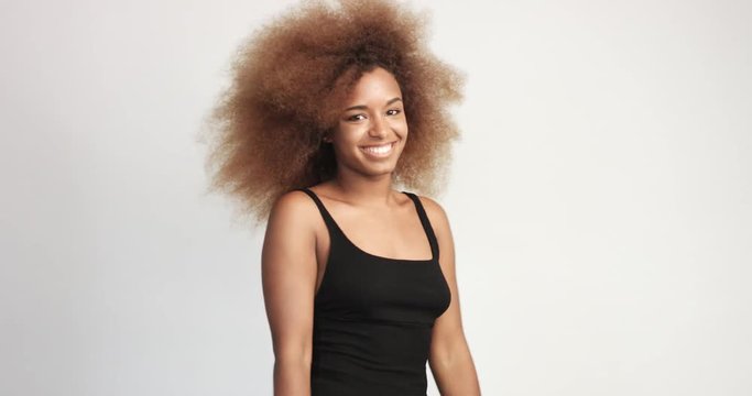 beuayt black woman with a huge afro hair having fun smiling and showing thumbs up