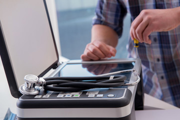 Repairman repairing broken color printer