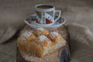 Traditional Turkish Dessert Baklava with Turkish Coffee on A Wooden Plate