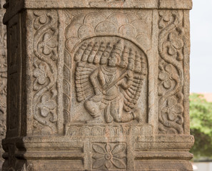 Nanjangud, India - October 26, 2013: Closeup of chiseled mural of Lord Ravana with his ten heads  in beige sandstone of the Mandapam at Srikanteshwara Temple.