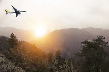 Fototapeta na wymiar Morning flight on amazing view. airplane overlooking sunrise, mountain in the of forest mist and everything nice in yellow light view