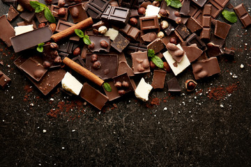 Heap of broken chocolate pieces on table
