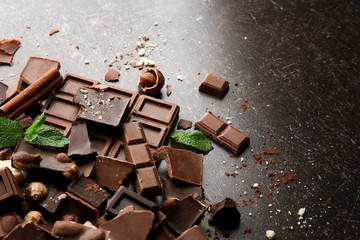 Heap of broken chocolate pieces on table