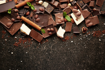 Heap of broken chocolate pieces on table