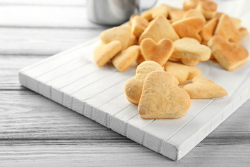 Butter cookies in shape of heart on wooden table