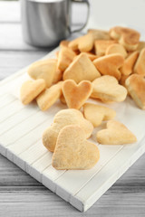 Butter cookies in shape of heart on wooden table
