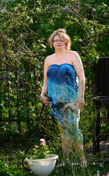 Russian beauty-beautiful woman standing in the garden on a sunny summer day