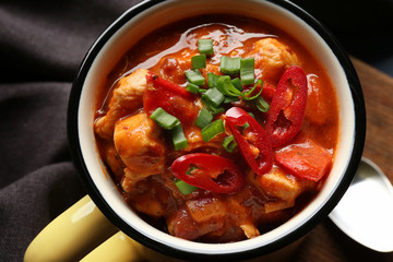 Enamel mug with delicious chili turkey, closeup