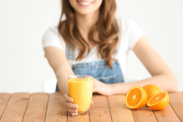 Weight loss concept. Beautiful young woman sitting at table with healthy delicious smoothie on white background