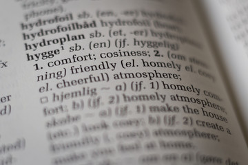 Close up of dictionary with the Danish word hygge translated to English