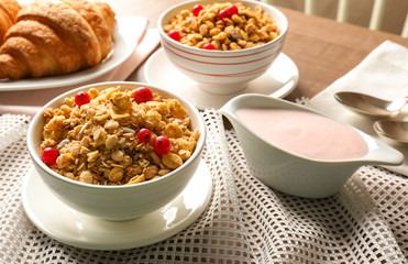 Healthy breakfast with muesli and yogurt on table