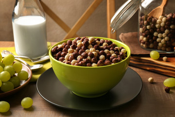 Healthy breakfast with corn balls and grapes on table