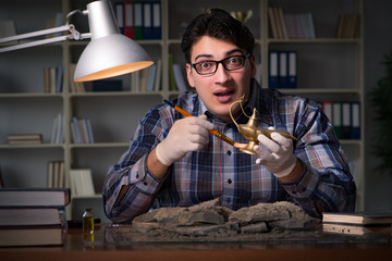 Archeologist working late night in office