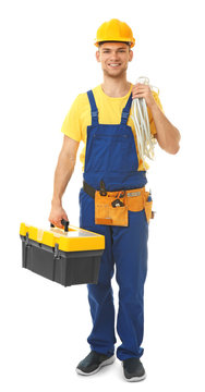 Young smiling electrician with bunch of wires and toolbox on white background