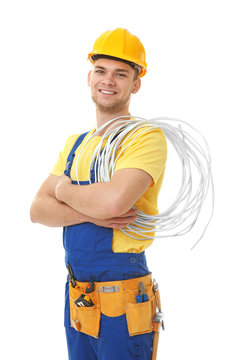 Young smiling electrician with bunch of wires on white background