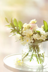 Beautiful bouquet with white freesia flowers on table at home