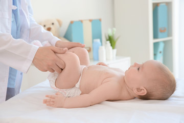 Doctor examining little baby in clinic. Baby health concept